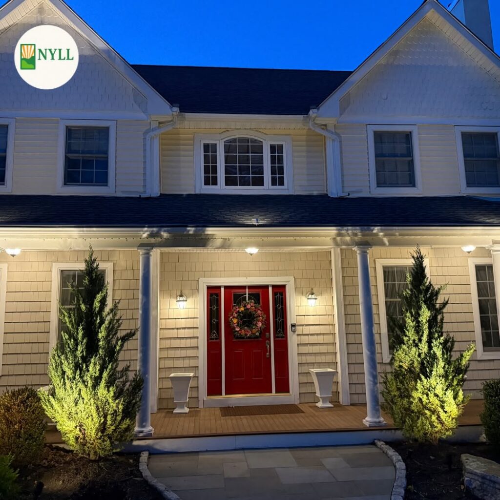 orch and eave downlighting with juniper uplighting on a shingle-style colonial, Post Road, Scarsdale NY