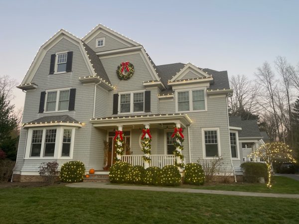 Ridgefield Connecticut home with warm white Christmas lights outlining the roof and landscaping
