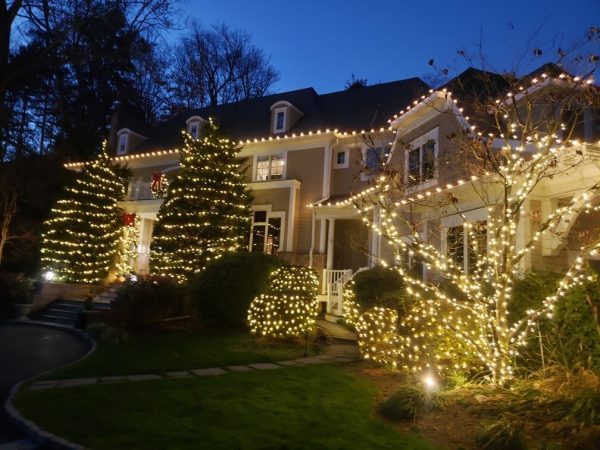 Residential Christmas lighting with warm white lights on a Greenwich CT home.