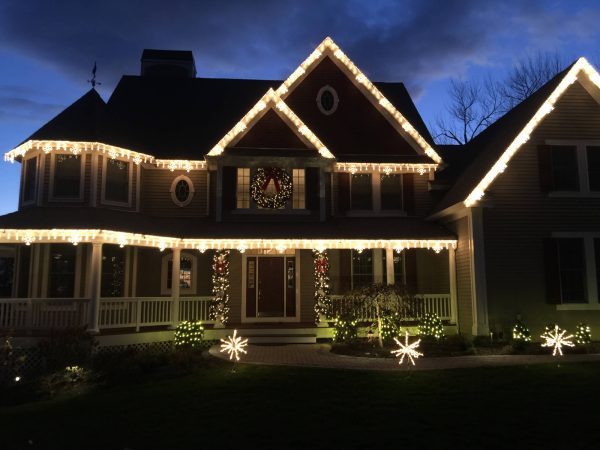 Ridgefield CT home decorated with professional Christmas lights, wreaths and illuminated landscaping